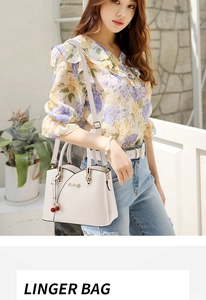 White PU leather handbag for women featuring a cherry charm and detachable shoulder strap