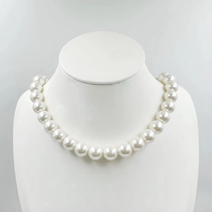 Detail of high-luster round white pearl necklace on a professional jewelry display
