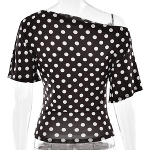Detail of one-shoulder black polka dot top with elastic knitted fabric on mannequin