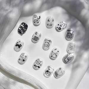 Detail of embossed nail stickers featuring cute hand-drawn cats and stars designs