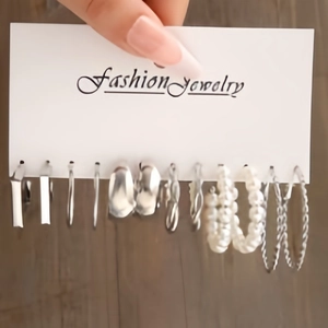 Detail of 12-piece silver earring set featuring geometric hoops and faux pearl accents