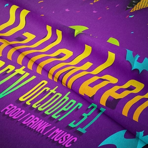 Detail showing the soft flannel texture and Halloween Party text on a purple tapestry