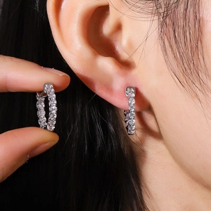 Detailed close-up of a silver hoop earring featuring brilliant micro-pave cubic zirconia