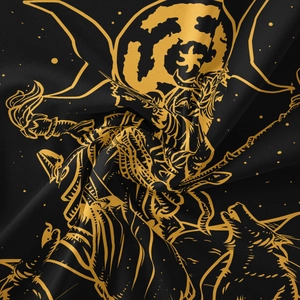 Detail of bohemian sun and moon tapestry with gold mystical patterns on black fabric