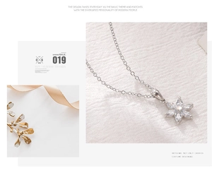 Macro shot of silver flower pendant with marquise-cut zircons on a delicate chain
