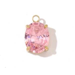 Macro shot of oval pink zircon pendant with gold four-claw setting on white background
