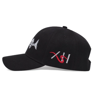 Detail of fishbone embroidery and XH logo on a black cotton baseball cap side view