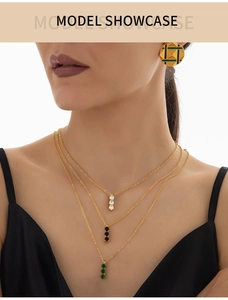 Three-layer titanium steel necklace with white, black, and green zircon pendants on model