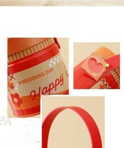 Detail of red metal gift bucket with leather handle and heart-shaped love tag
