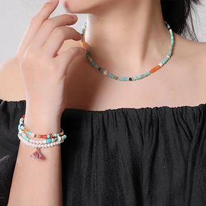 Detail of beaded necklace with natural blue turquoise, pearls, and a decorative fringe tassel