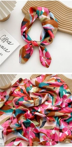 Detailed view of floral satin silk square scarf showing smooth texture and edge craftsmanship