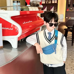 Blue nylon kids chest bag worn by a boy in a modern cafe setting for outdoor travel