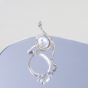 Macro view of silver snake ring featuring detailed scales and a large white pearl