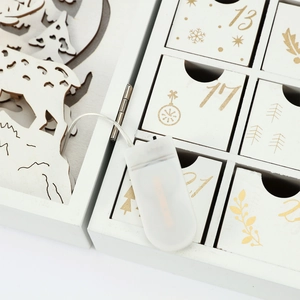 Detail of wooden advent calendar featuring numbered drawers and external battery box