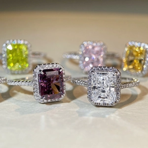 Detail view of S925 silver rings featuring radiant cut colorful gemstones with halo setting