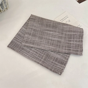 Detailed macro view of heat-resistant plaid fabric placemat for home dining table