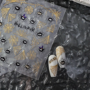 Metallic Halloween nail stickers featuring gold spider webs and cute black spiders