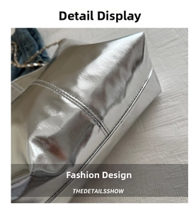 Detail showing high-shine silver leather texture and stitching of the bucket bag