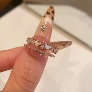 Detailed macro of heart-shaped shell inlay and pave set cubic zirconia double layer ring