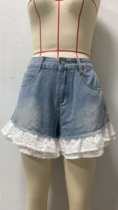 Détail du short en jean taille haute avec bordure en dentelle blanche brodée double couche