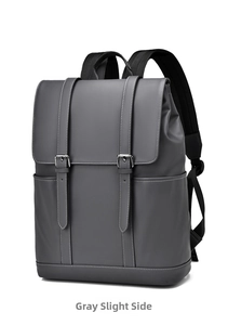 Detail view of a gray PU leather backpack showing side pockets and flap buckle straps
