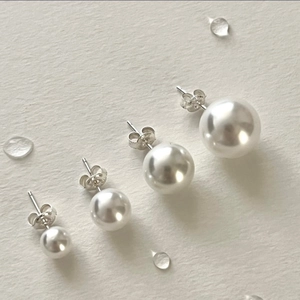 Elegant 925 sterling silver pearl stud earrings set with four round white pearls