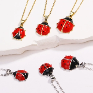 Detailed view of red ladybug pendant necklaces with gold and silver chain options