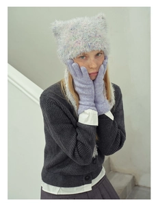 Close-up of lavender wool blend knit gloves on model posing in cozy winter outfit