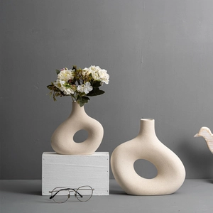 Minimalist beige donut ceramic vases with textured finish in a modern home decor setting