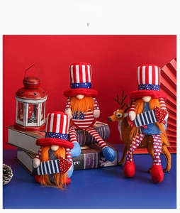 Detailed display of three patriotic gnomes with American flag patterns in a festive setting