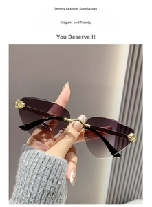 Detail of purple gradient rimless sunglasses with gold metal cheetah head and temple hinge