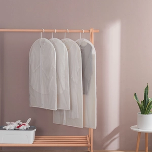 Set of four semi-transparent PEVA garment covers with zippers in a home closet