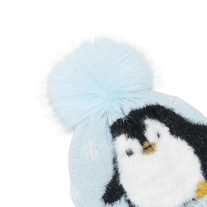 Detailed close-up of a blue knitted child hat featuring a cute plush penguin applique