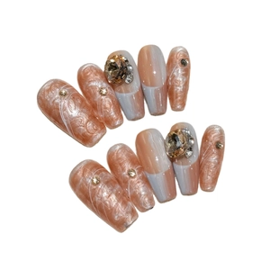 Handmade marble nude press-on nails with champagne crystals and long coffin shape