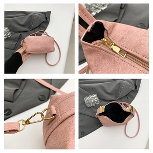 Detail shots of pink suede crossbody bag with gold zippers and metal strap hooks