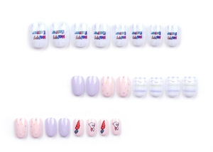 Detailed view of pink and lilac Easter press-on nails with bunny and carrot patterns