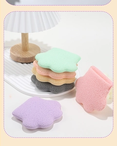 Macro view of pastel petal-shaped cleansing sponges in pink, purple and green tones