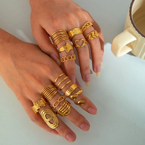Close-up of model wearing gold 18K plated stainless steel rings in various geometric shapes