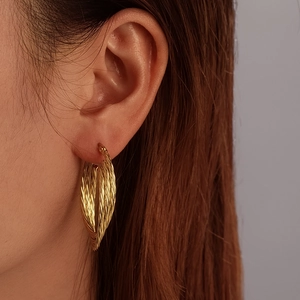 Chic multi-layer gold twisted weave earrings for women shown on ear for a stylish look