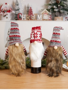 Three-piece set of knitted Christmas gnome wine bottle covers with gnome hat detail