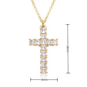 Detailed view of gold cross pendant necklace with white zircons measuring 28mm by 16mm