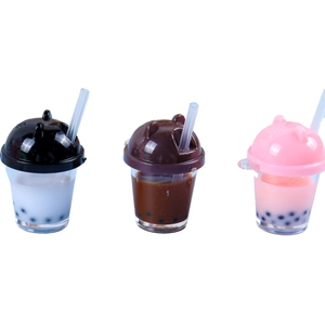 Three mini bubble tea keychains with cat ears and liquid pearls in black brown and pink