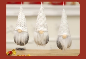 Three knitted Christmas gnomes with white hats and soft plush beards hanging as ornaments
