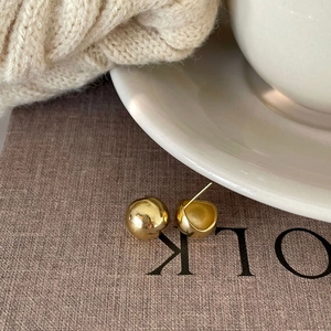 Minimalist 925 sterling silver gold plated semi-ball stud earrings on textured fabric