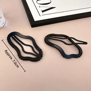 Pair of black wave-shaped BB hair clips with fine bead embellishments and alloy base