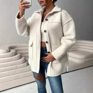 Detailed view of white sherpa fleece jacket texture with large buttons and front pockets
