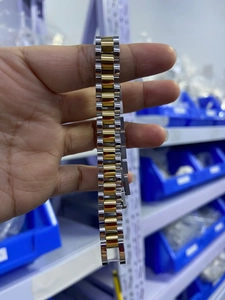 Detail shot of a two-tone silver and gold stainless steel jubilee watch strap bracelet