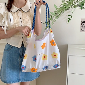 Floral canvas tote bag with deep blue rope handles and Sozakka logo in lifestyle setting