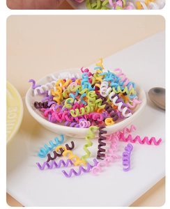 Close-up of colorful polymer clay spiral faux chocolate rolls for DIY dessert decoration