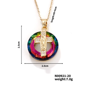 Detailed close-up of a gold oval Virgin Mary pendant with colorful crystal accents